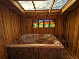 Hot tub with skylight for starry nights.