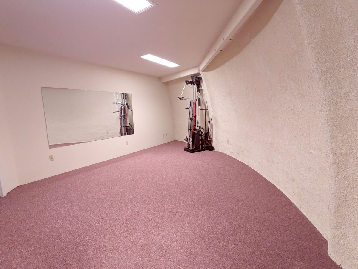 Exercise room. Gym equipment included.