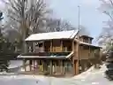 Solar Panels on Lakehouse providing deep penetration of winter sunlight plus solar energy.  Solar panels shade the building in the summer.
