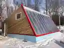 Deep Winter Greenhouse (DWG) heats rocks below the floor during the day that heat the growing room at night.  The temperature never drops below 40 F.