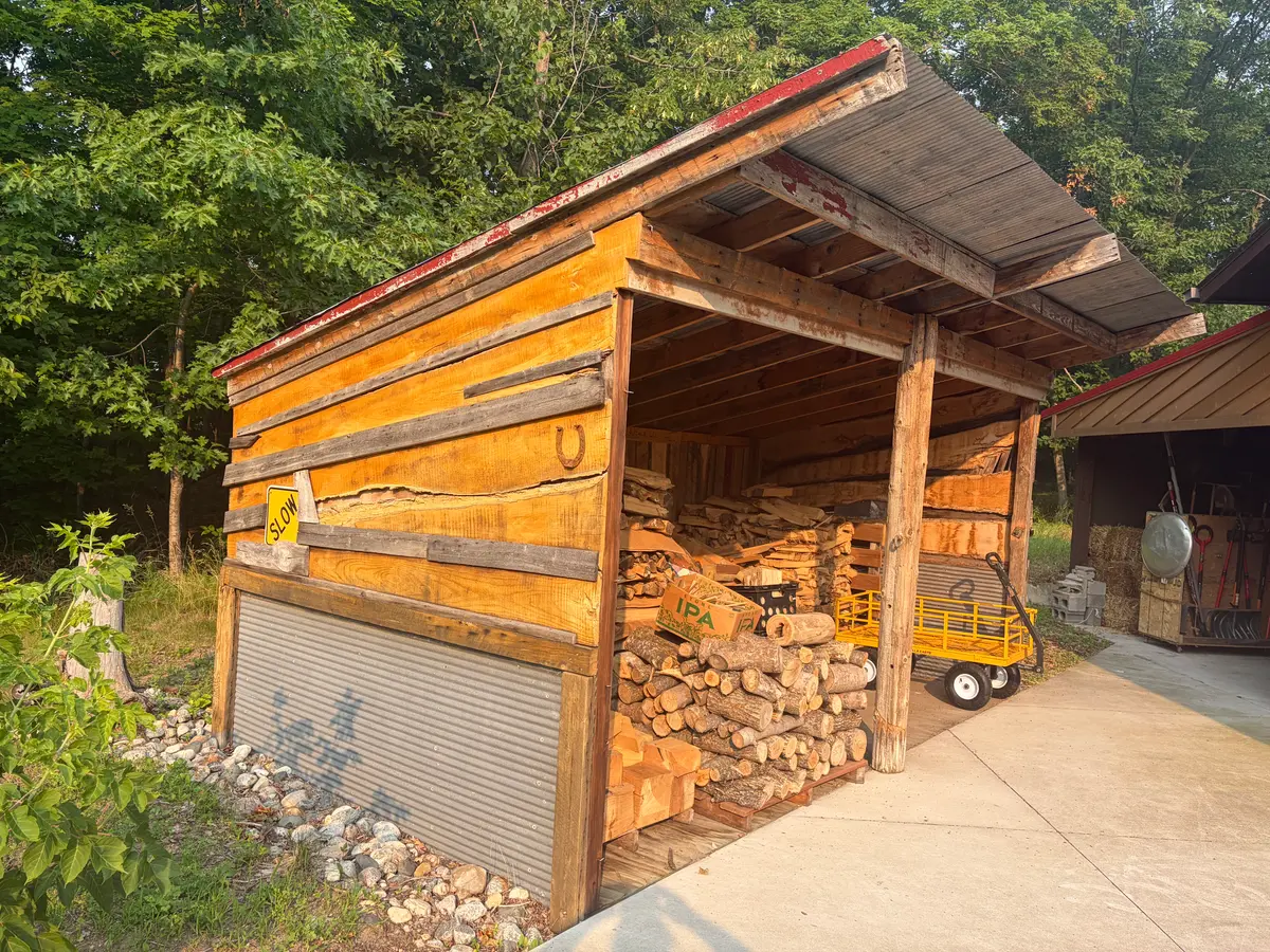 Firewood shed made from recycled building materials.