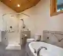 Primary Bath - Roll-in shower and soaking tub. Doors are 3 ft. wide and handicap accessible on the main level.