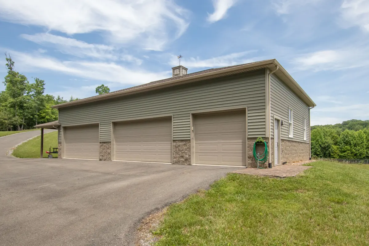 Detached 4 bay garage with workshop and a half-bath.