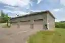 Detached 4 bay garage with workshop and a half-bath.