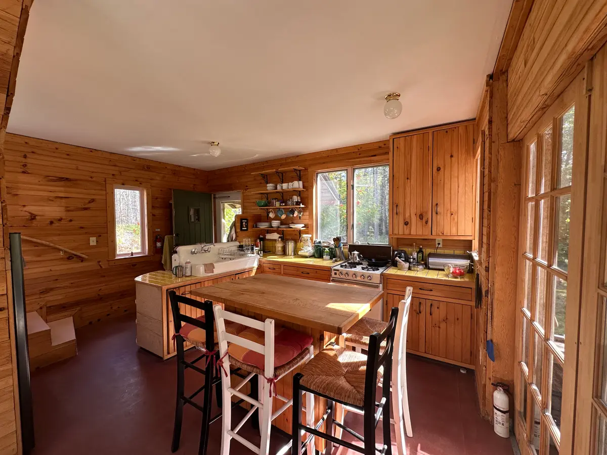 Kitchen looking out onto the screen porch overlooking the pond