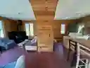 downstairs living room on left; kitchen right; stairs in the middle