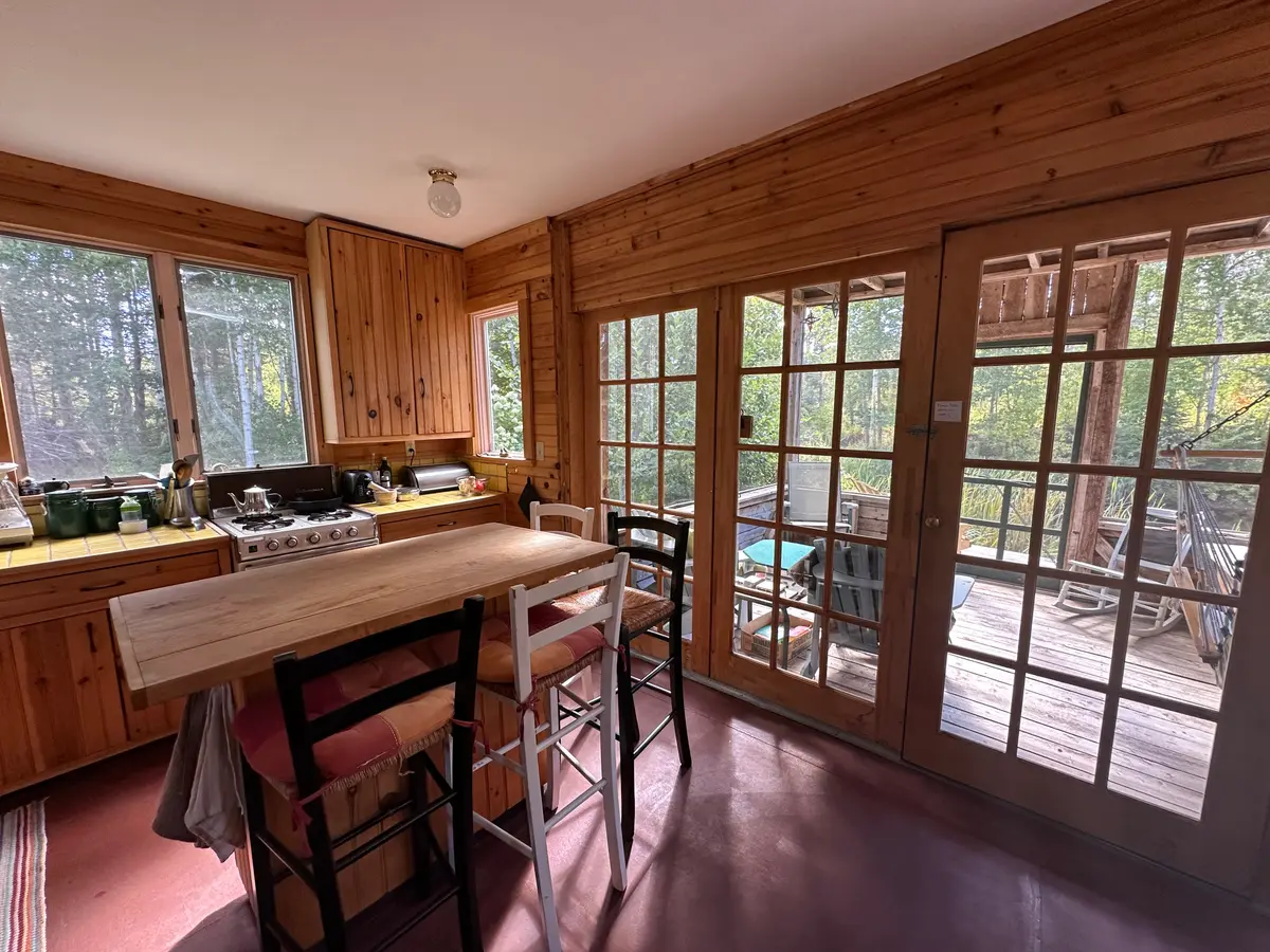 Kitchen looking out onto the screen porch overlooking the pond 2