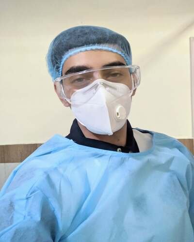 Dr. Ramit Singh Sambyal wearing scrubs in his clinic Dr. Ramit Singh Sambyal wearing scrubs in his clinic