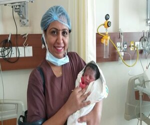 Dr Anu Sidana with a new born child Dr Anu Sidana with a new born child