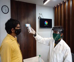 Dr Yogesh Jadhav's Advanced Speciality Homeopathy clinic taking thermal scanning for covid precautions