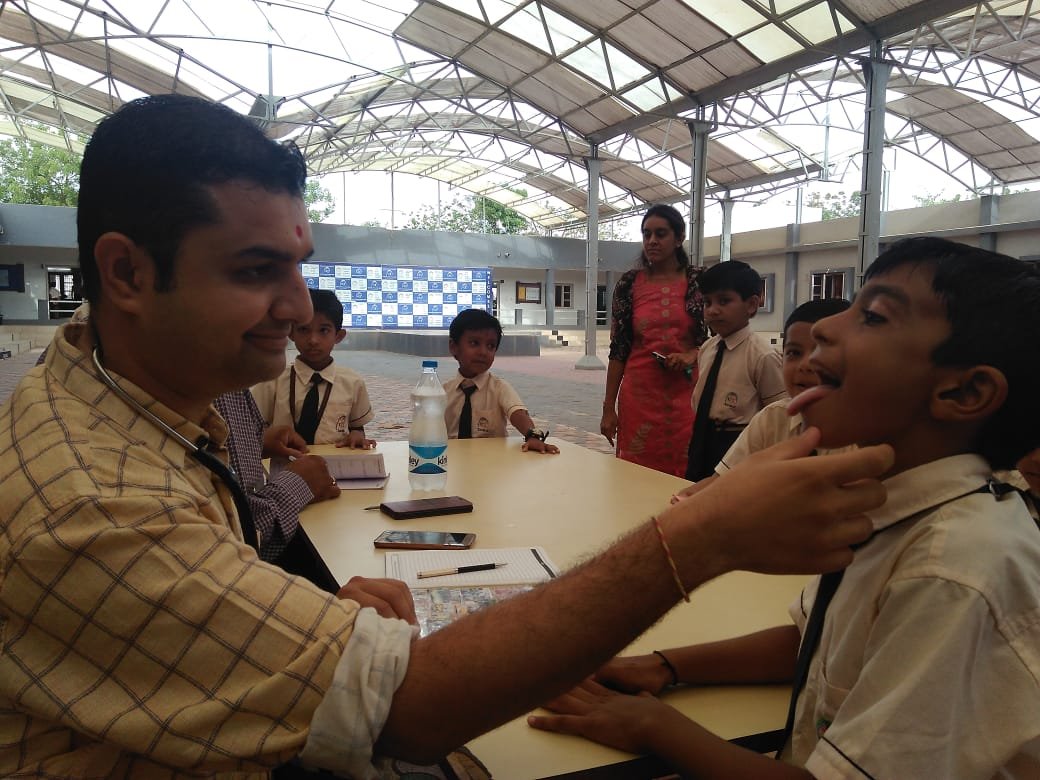 Dr. Dipesh checking up children at Sanskar School, Bhuj