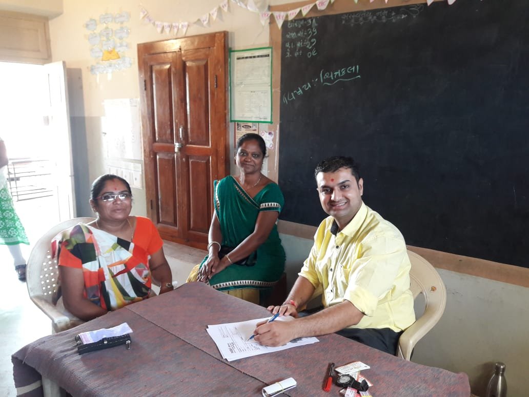 Dr. Dipesh providing free check-up and consultation to people in Samatra Village