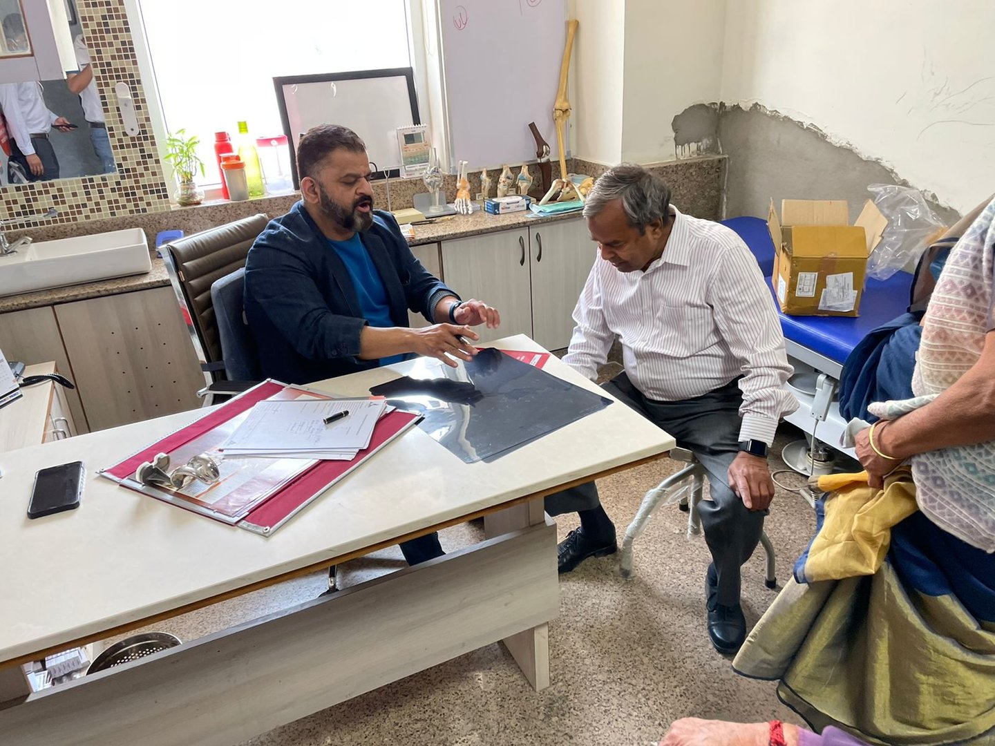 Doctor consulting patients in his clinic