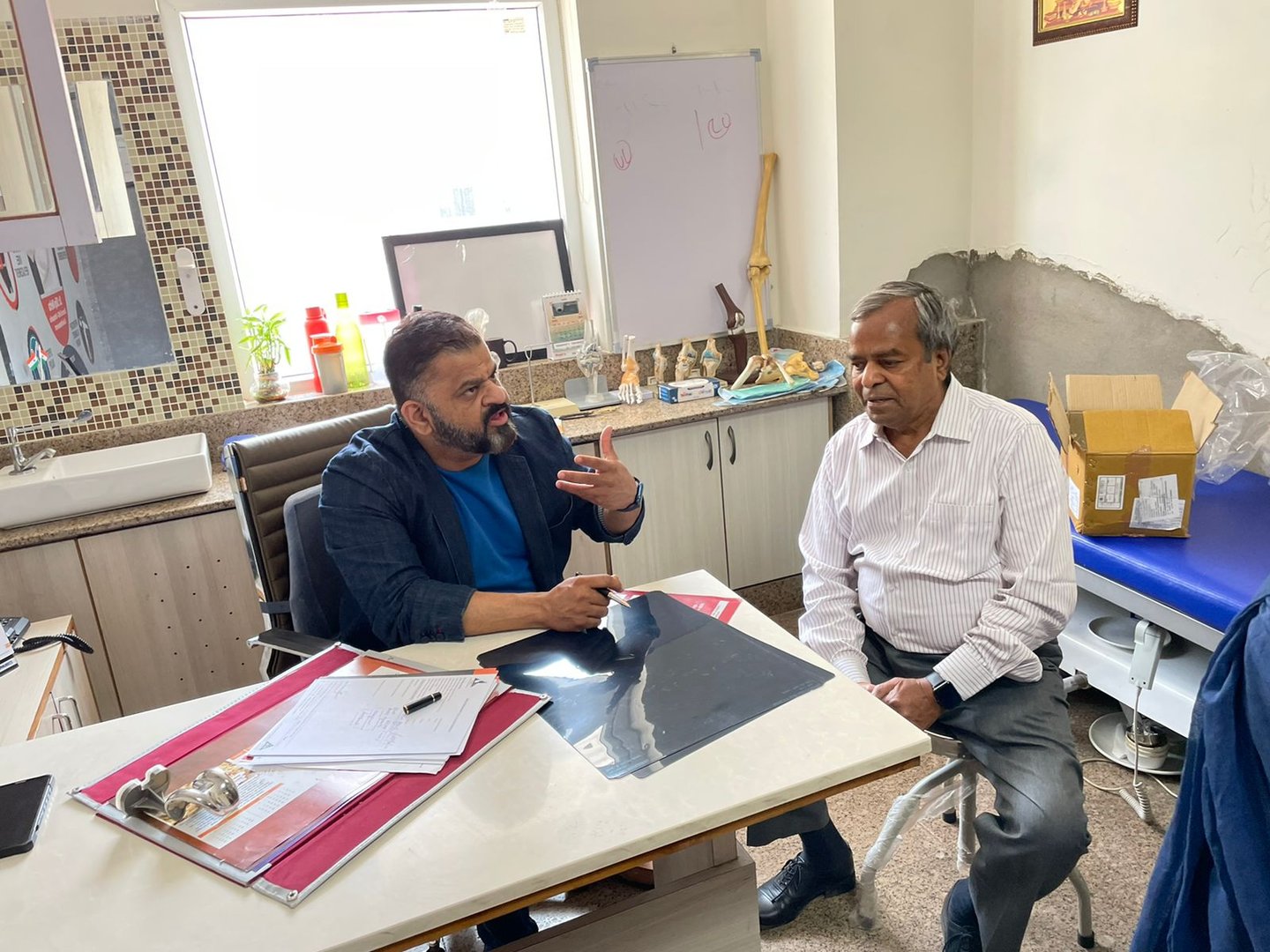 Doctor consulting patients in his clinic