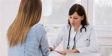A doctor talking to a patient
Description automatically generated with low confidence