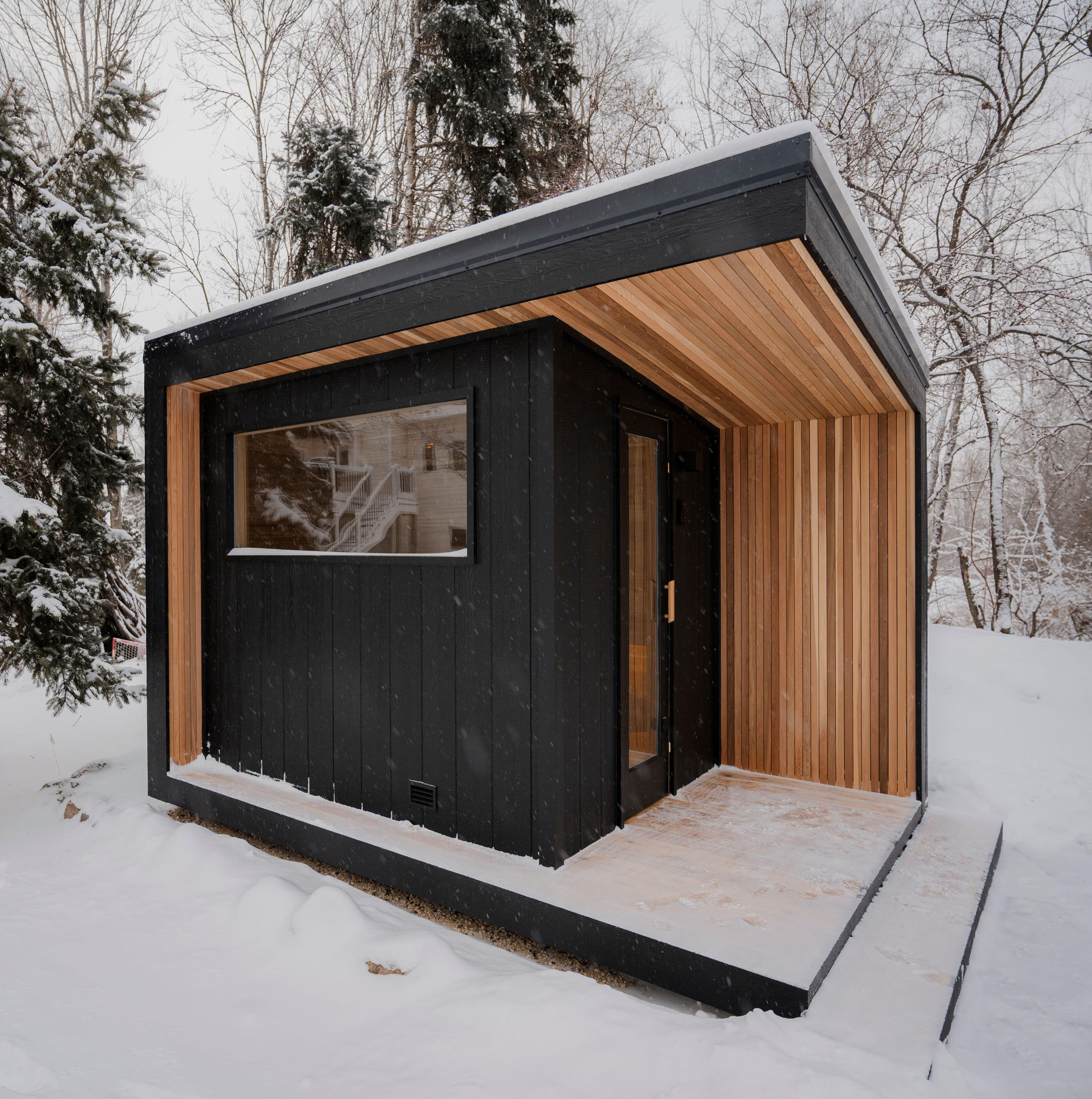 Tuli, Northern Steam's most popular 8x12 outdoor sauna in a snowy backyard