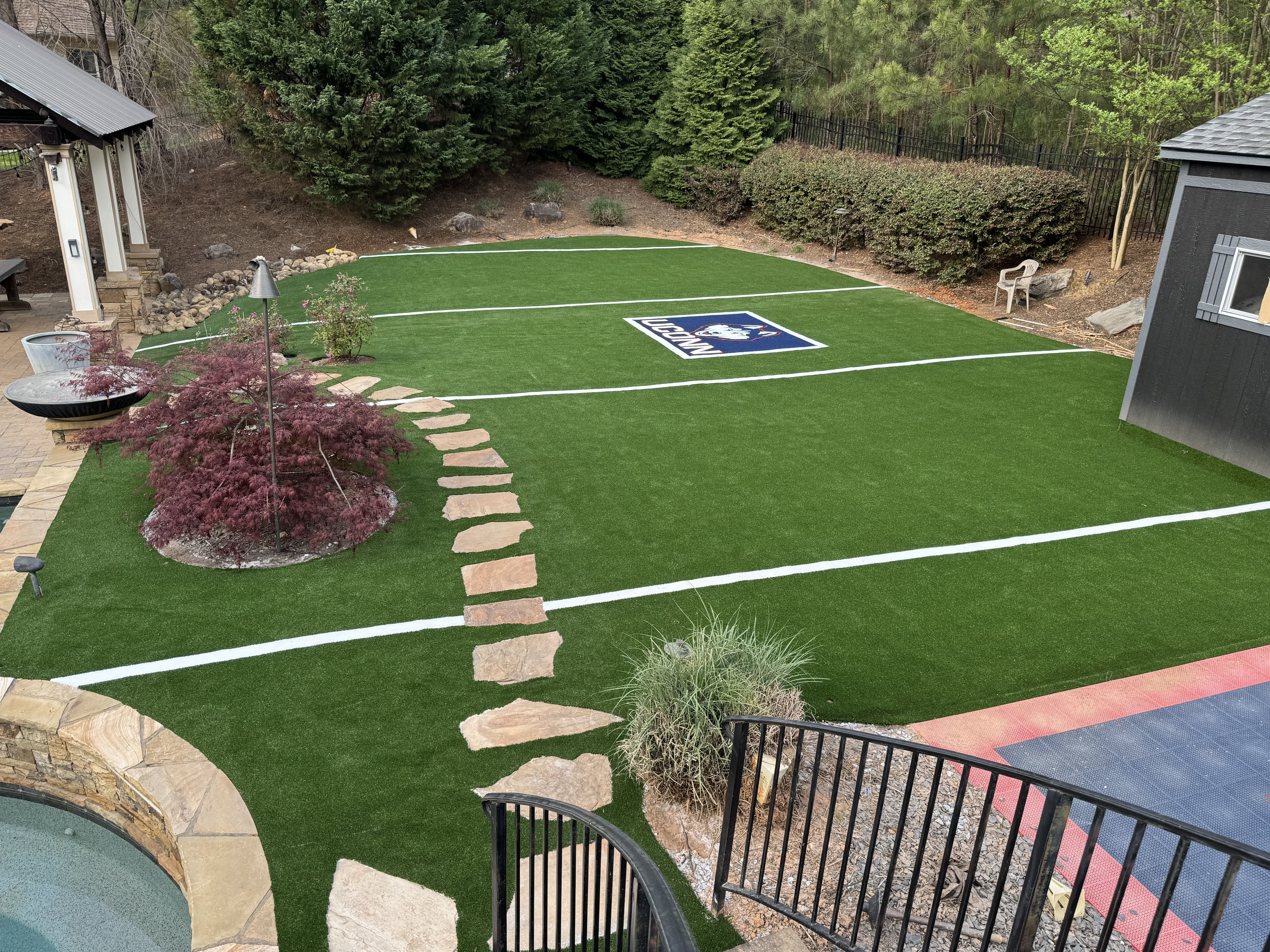 Backyard Mini Football Field with Custom UConn Logo Turf | Lazy Grass LLC