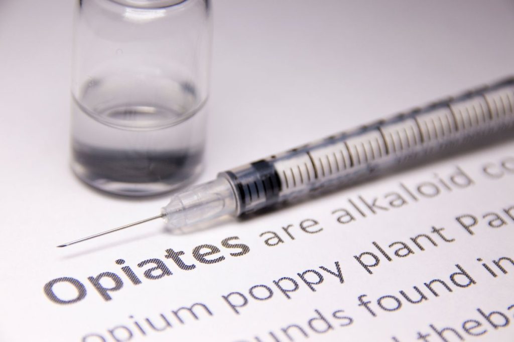 Opiates with syringe - southeastaddiction.com