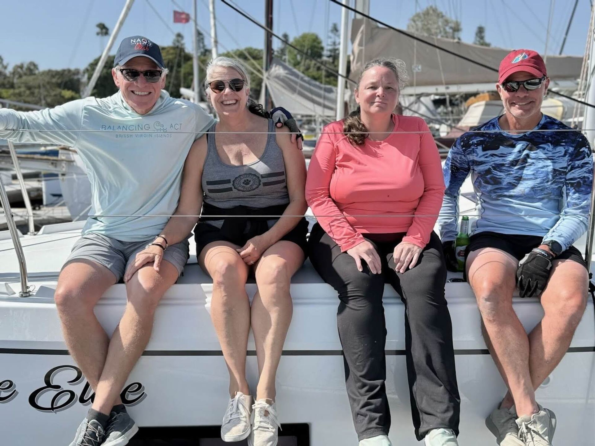 Multiple boats anchored in a bay at sunset during the flotilla.