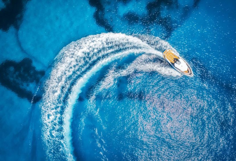 aerial view of the speed boat in clear blue water