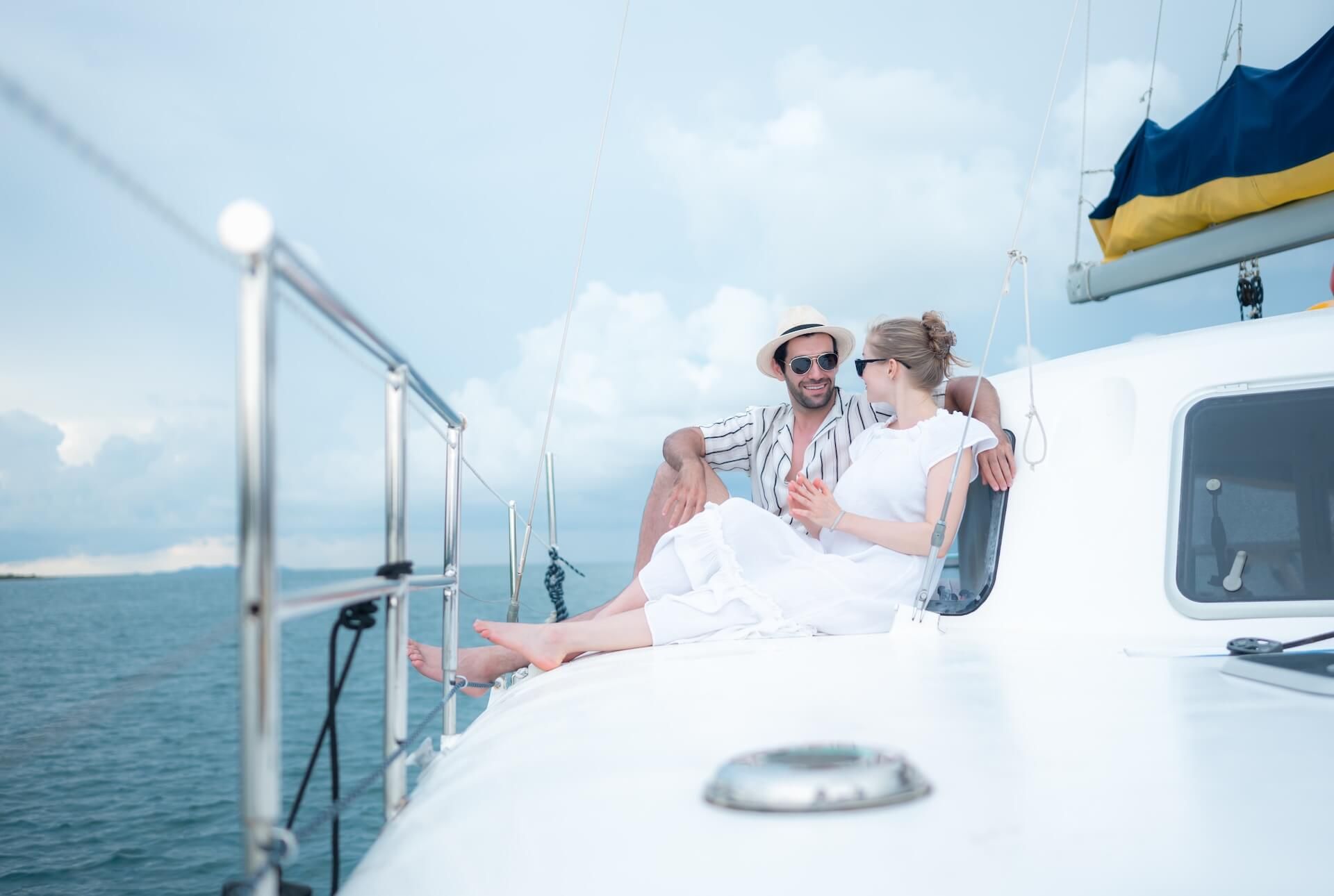 A young couple are enjoying seaside adventure aboard a yacht