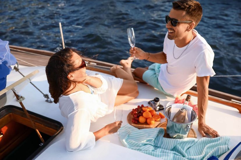 Happy young couple resting on yacht
