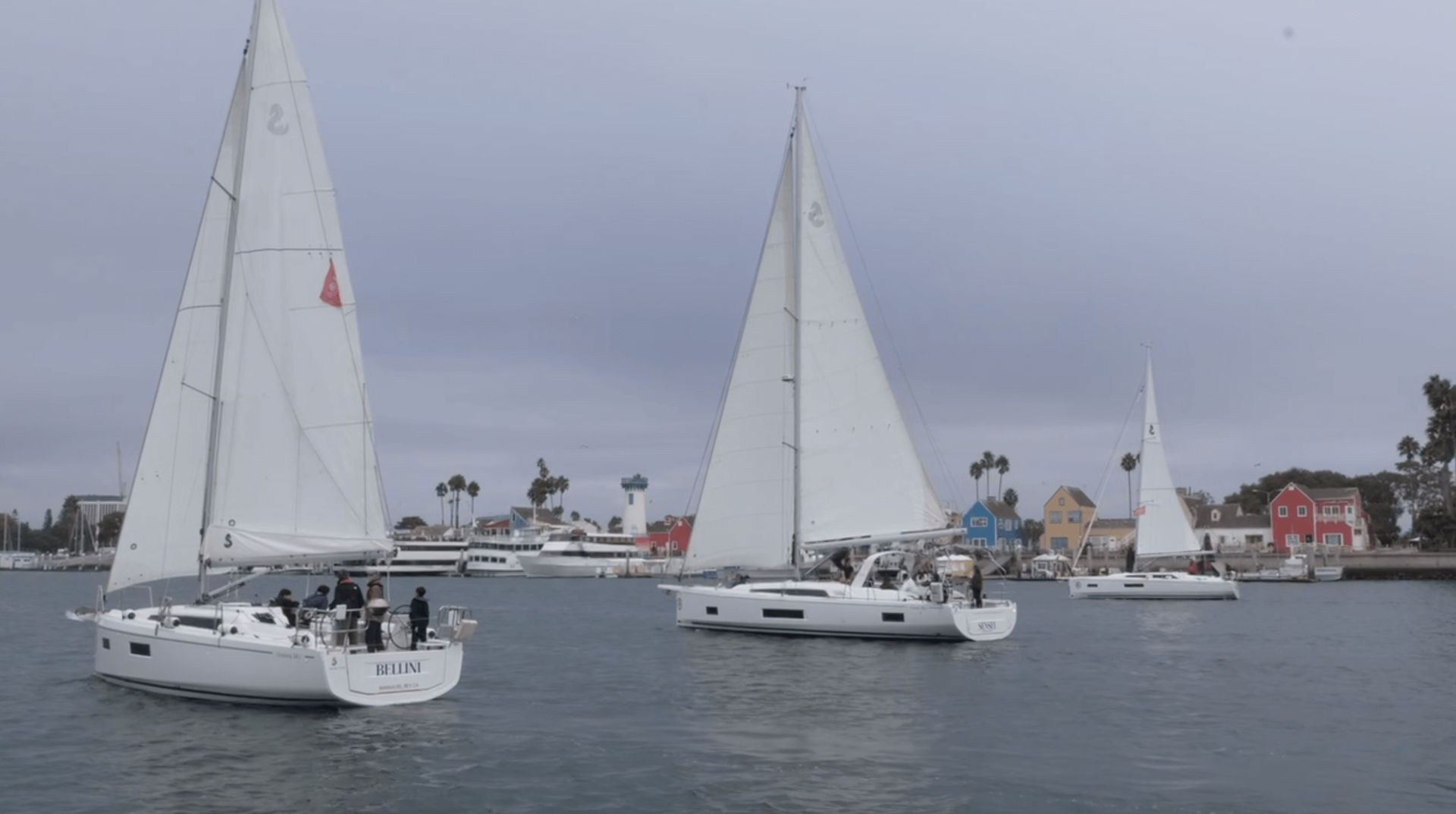 Sailing yacht navigating Marina del Rey waterways on a sunny day