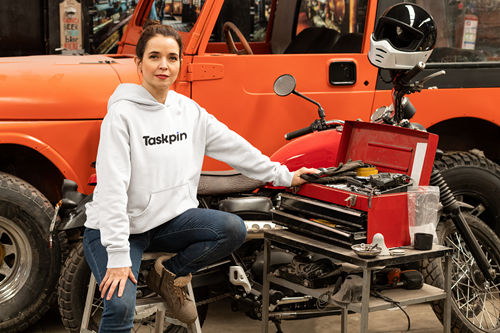 An orange top model car on an orange background surrounded by spanners