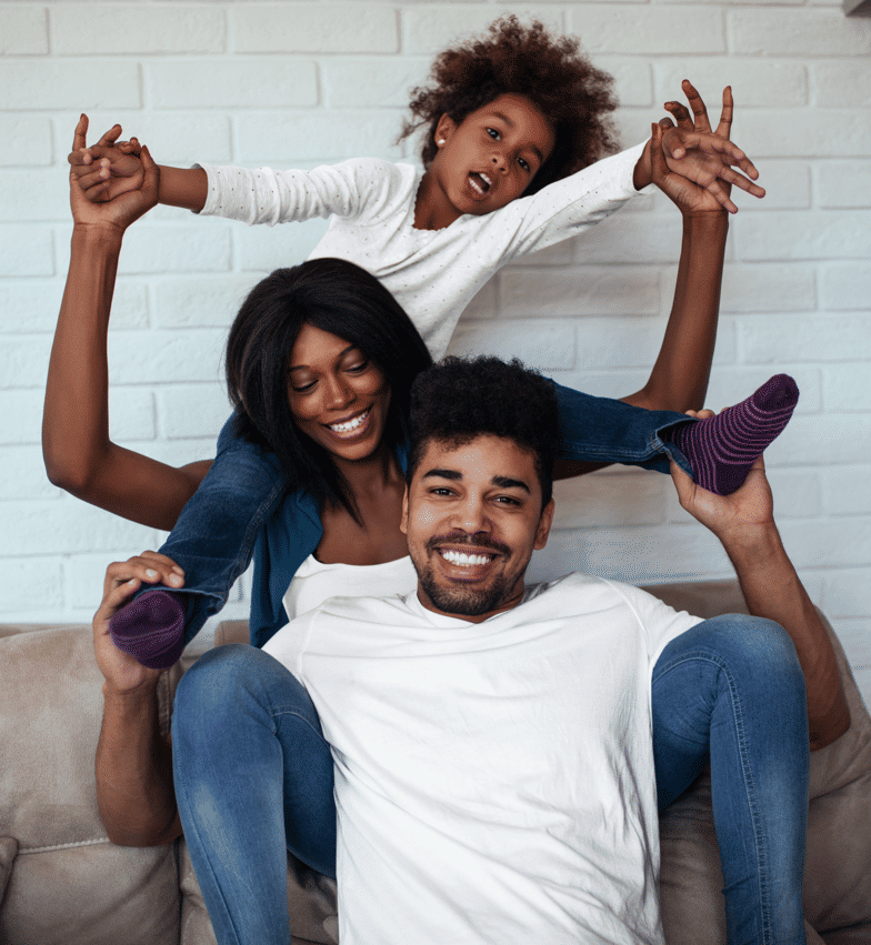 A smiling couple who recently moved to Toronto in their nostalgically decorated home