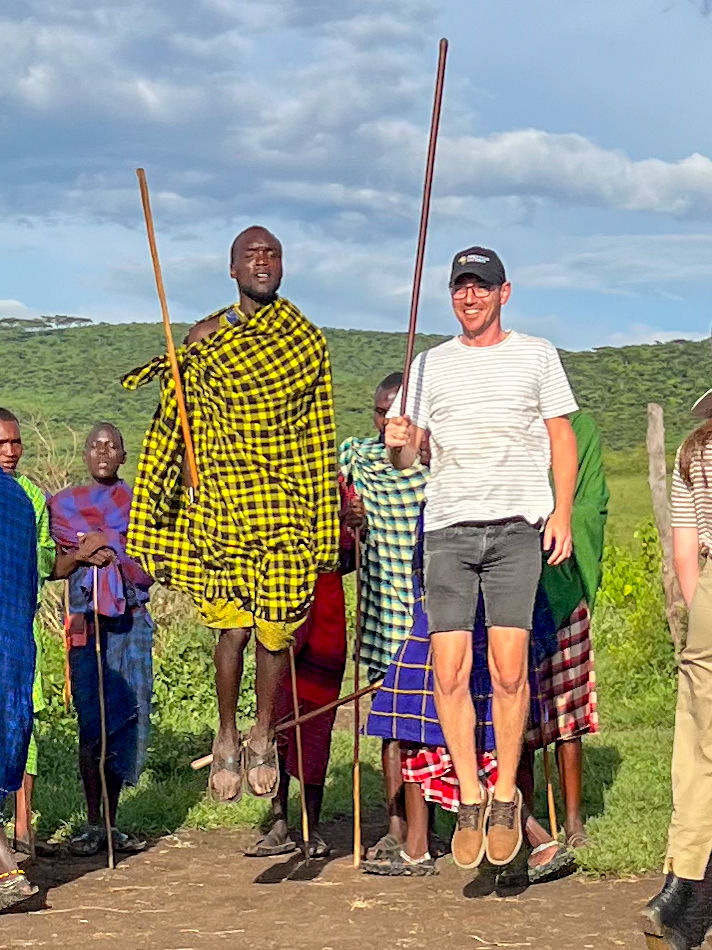 Chris Watson, travel expert, dancing with the Maasai people in Tanzania.