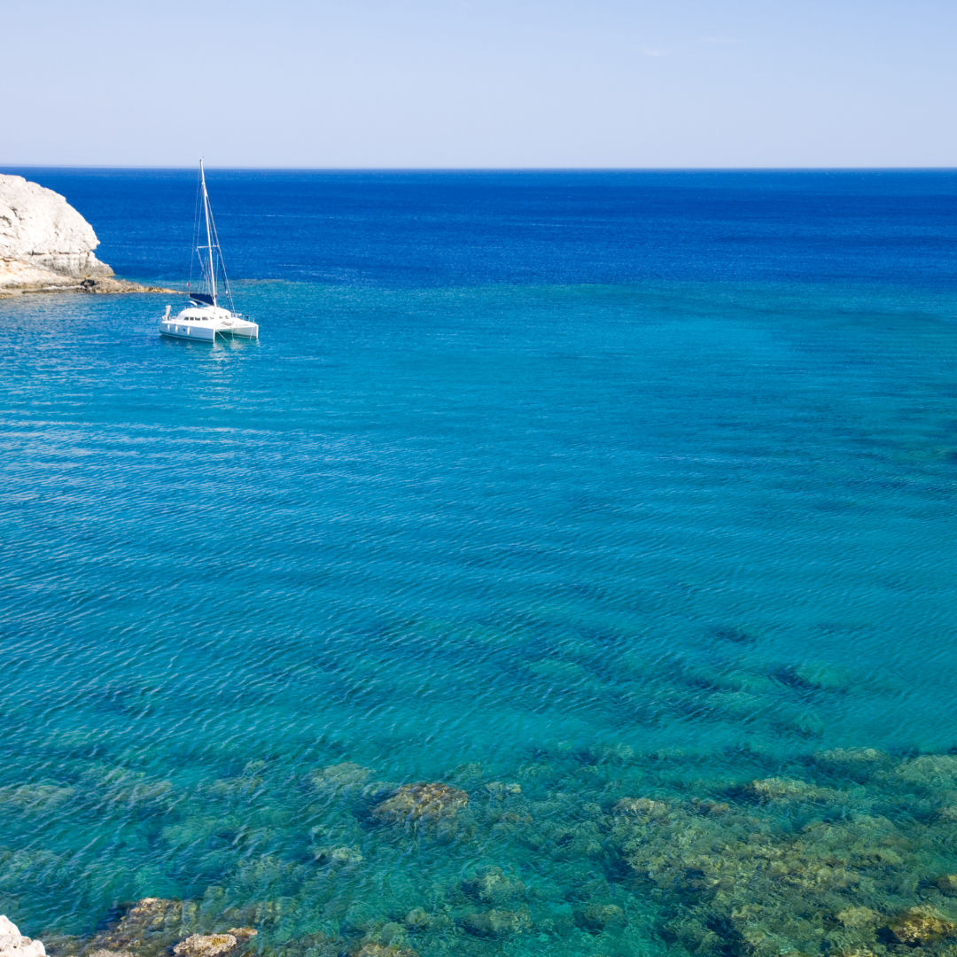 Sailing around Astypalea Island to find hidden coves, Greek Island private charter holiday. 