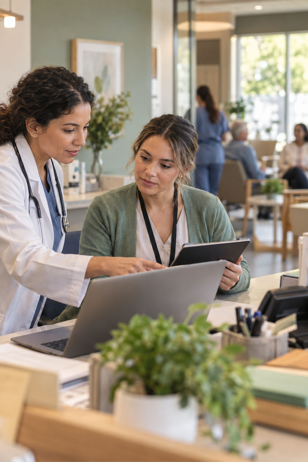 Clinician and care coordinator reviewing a digital workflow together in a clinic