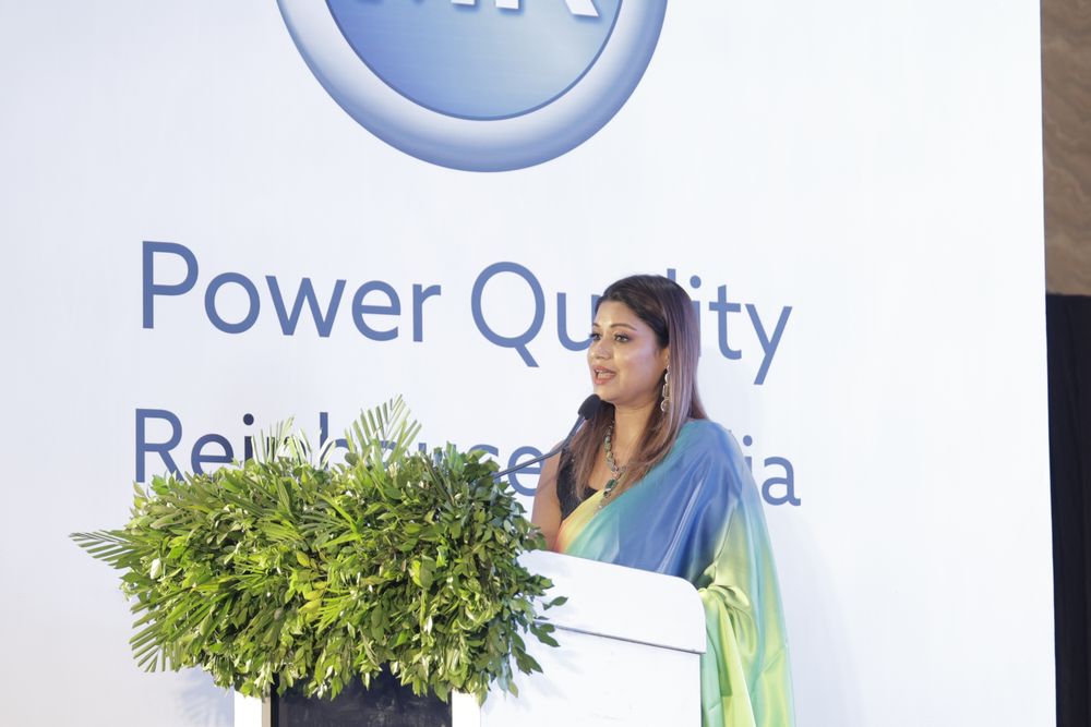 Monica Singh speaking at the podium at the MR Power Quality event