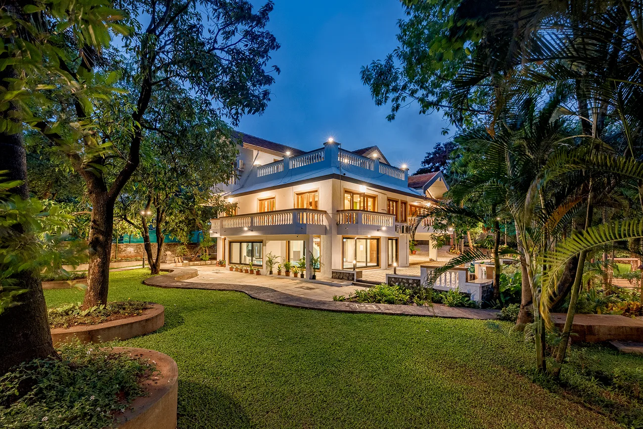 SaffronStays Windermere at twilight, a lit colonial villa in Lonavala