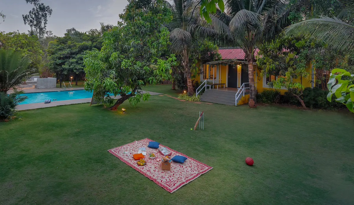Set up a cozy picnic on the lush lawn, enjoying good food and quality time with your loved ones
