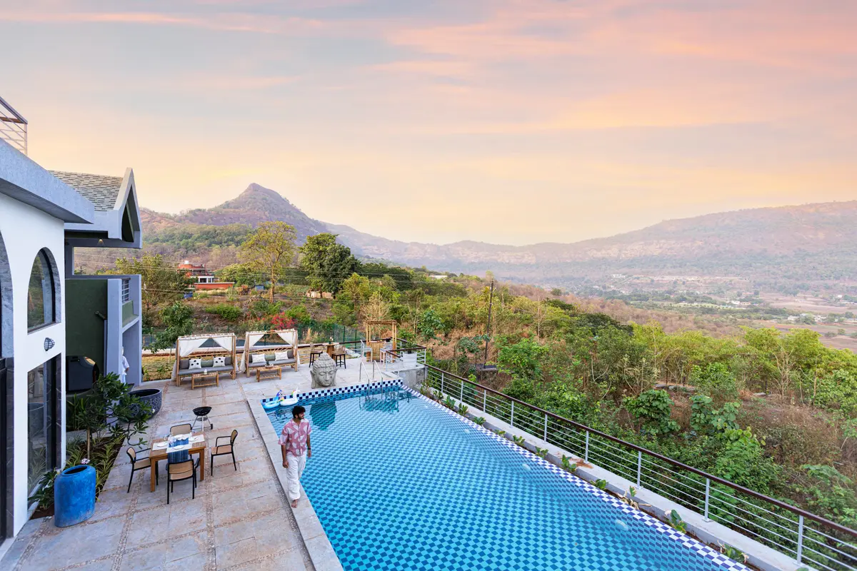 Dip in the swimming pool surrounded by tropical greens.
