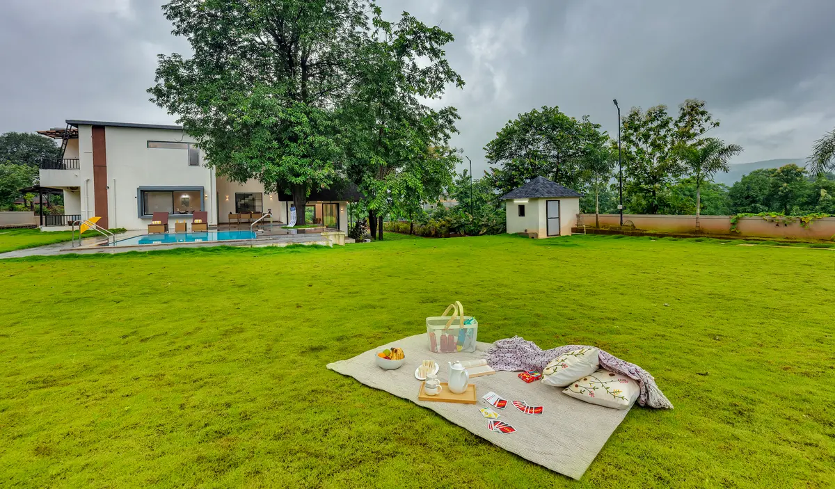 Enjoy a laid-back picnic on the lush green lawn, surrounded by nature - perfect for quality time with your family and furry friend.