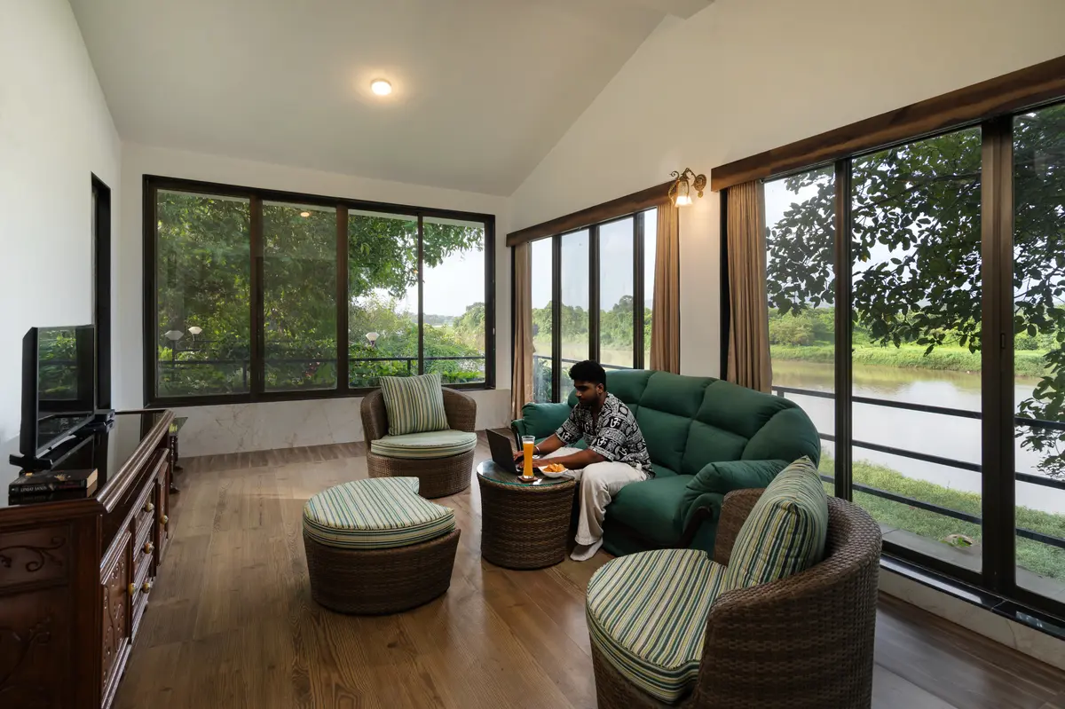 On the right side of the villa sits Riverstone Den, a white cabin with 270° riverside views perfect for laid-back movie nights and cozy game nights.