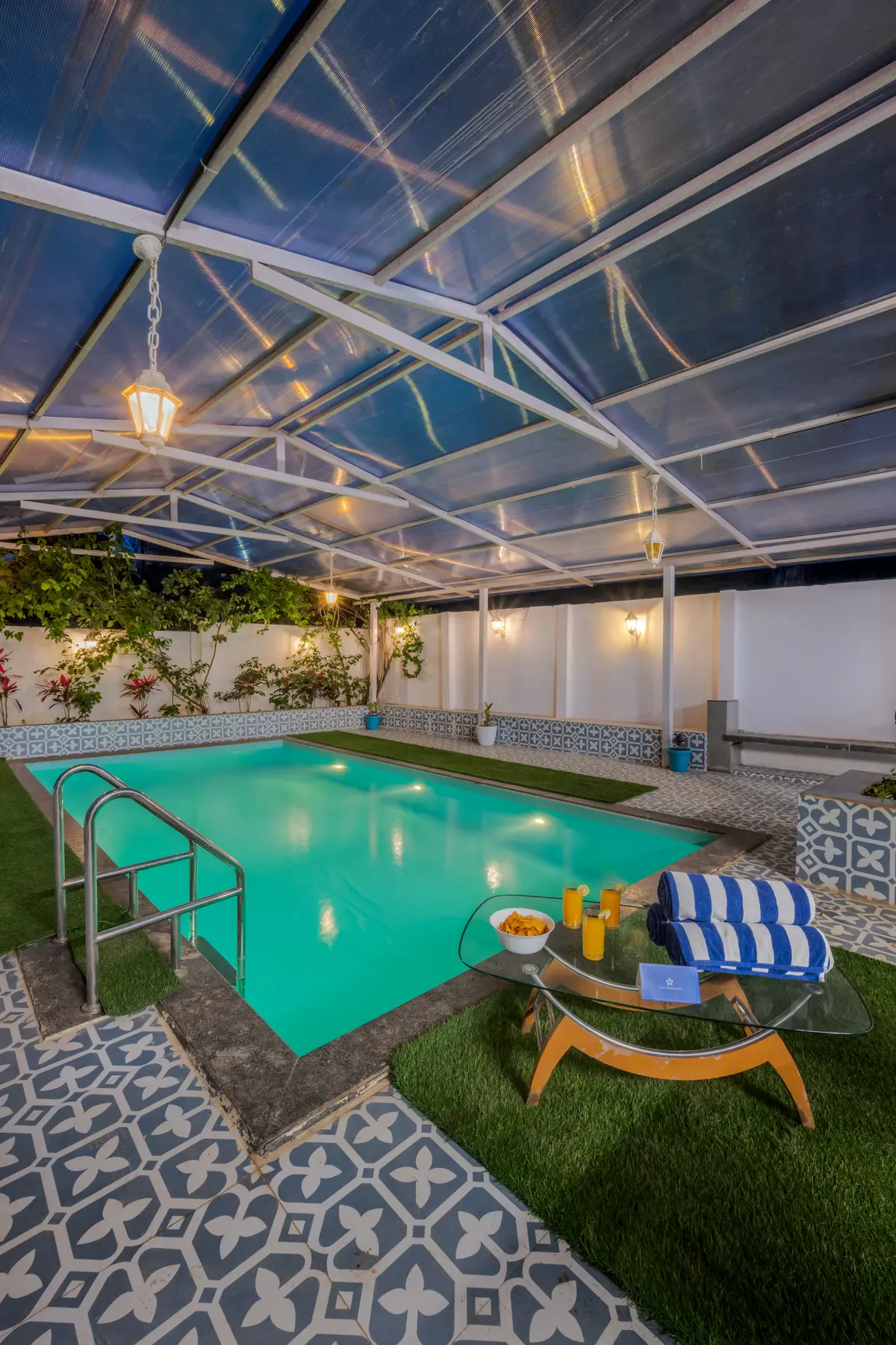Take a refreshing dip in the rooftop pool surrounded by lush plants, soaking in cool breezes and serene Greece-inspired vibes.