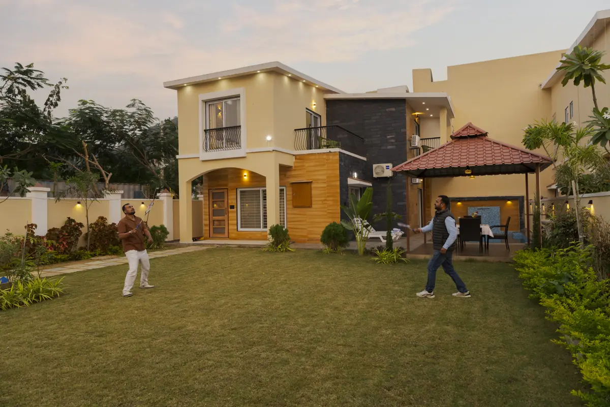 A Competitive game of badminton on the Lawn
