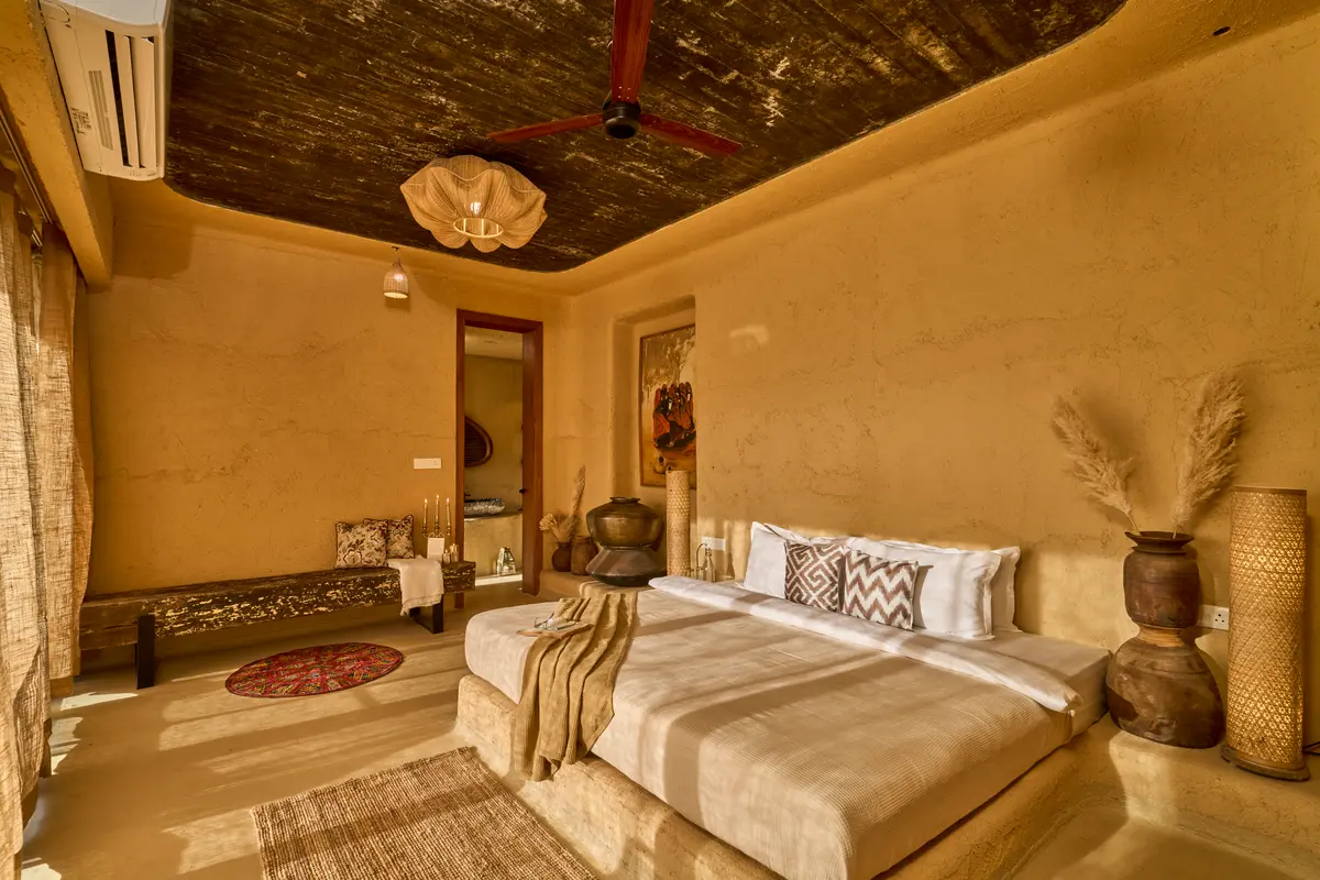 Sleep grounded in an earthy sanctuary, where clay and mud floors tell a story of timeless tradition.