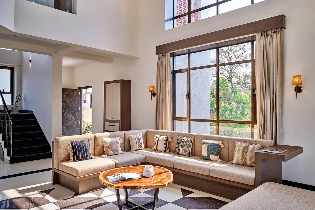 Curl up on a cosy couch where soft cushions, warm light, and unhurried moments come together