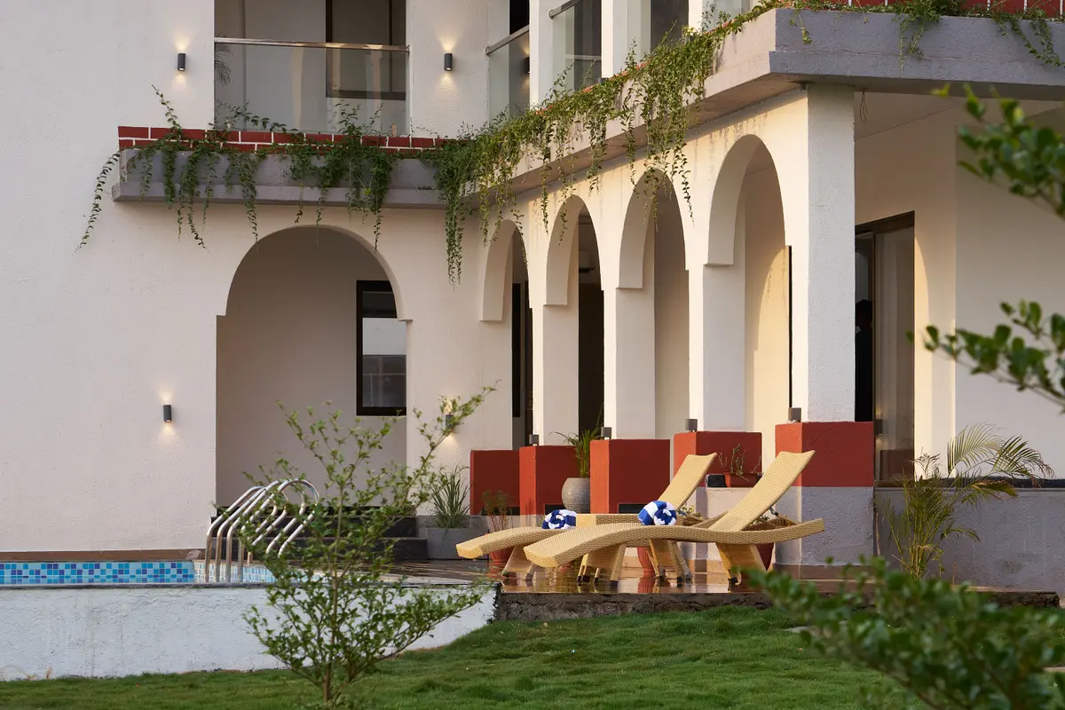 Lounge by the pool, toes dipped in the water as the sun sparkles and the day feels soft and slow.