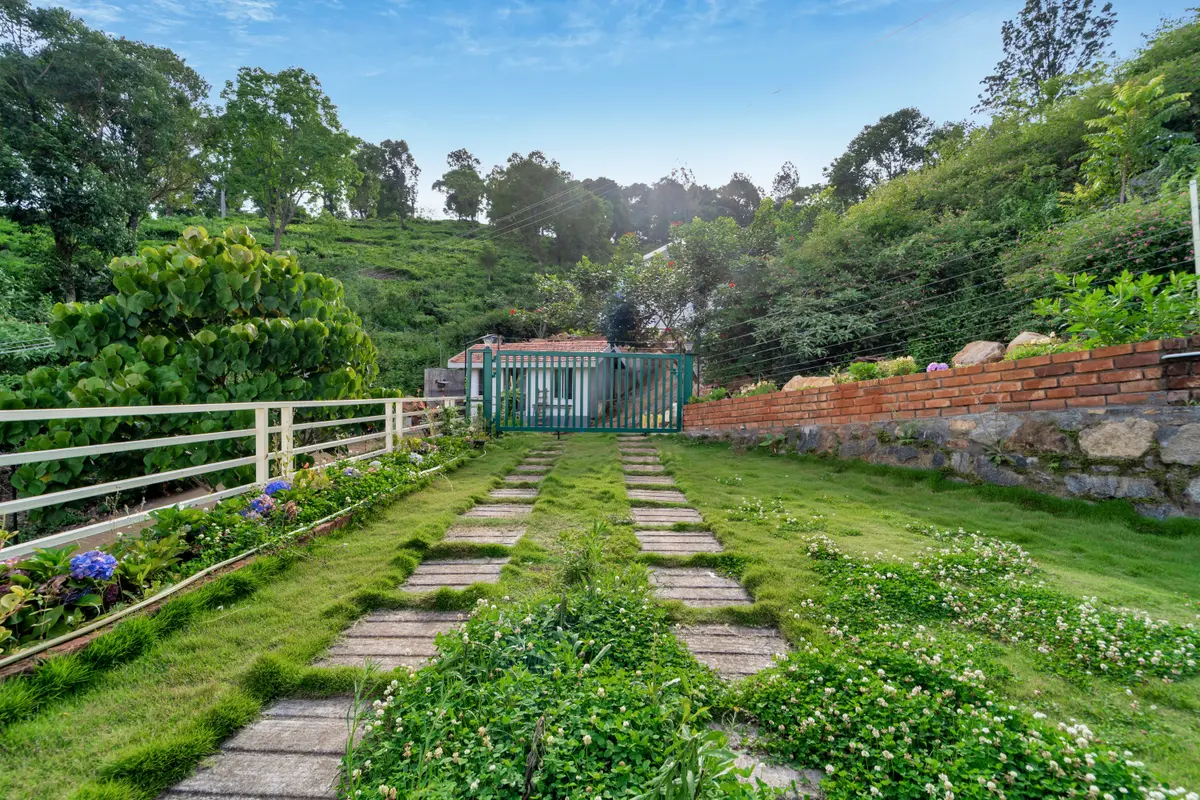 Stroll through lush gardens surrounded by the hills of Kotagiri.