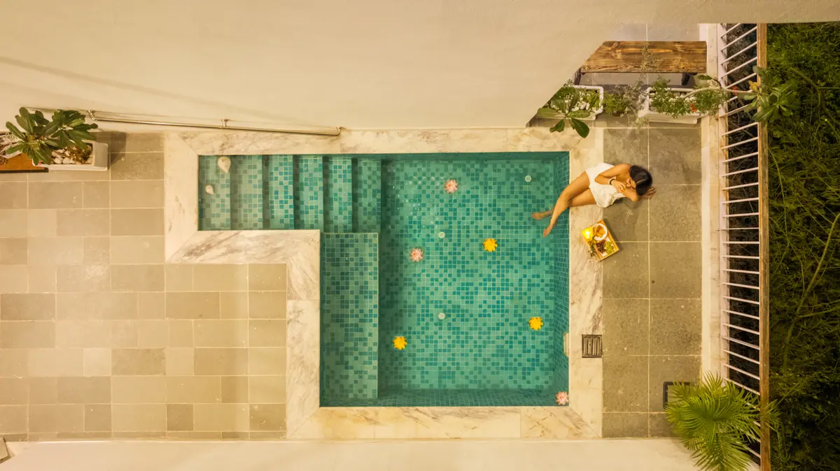  The sparkling pool reflects the sunlight, creating a shimmering effect