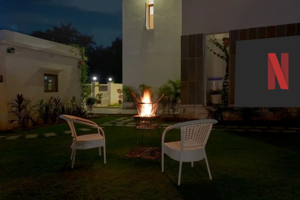 A stylish outdoor dining table is set with elegant tableware, ready for a meal