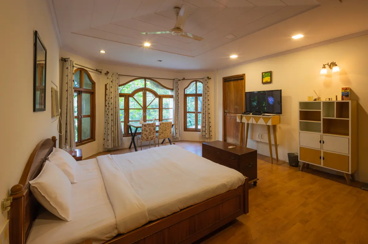Spacious bedrooms with wooden accents, reflecting the greenery outside.
