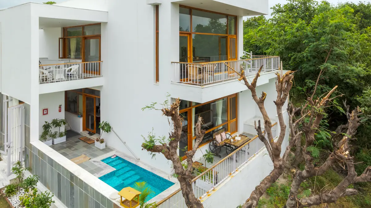 Large windows allow natural light to flood the interior, creating a bright and airy space