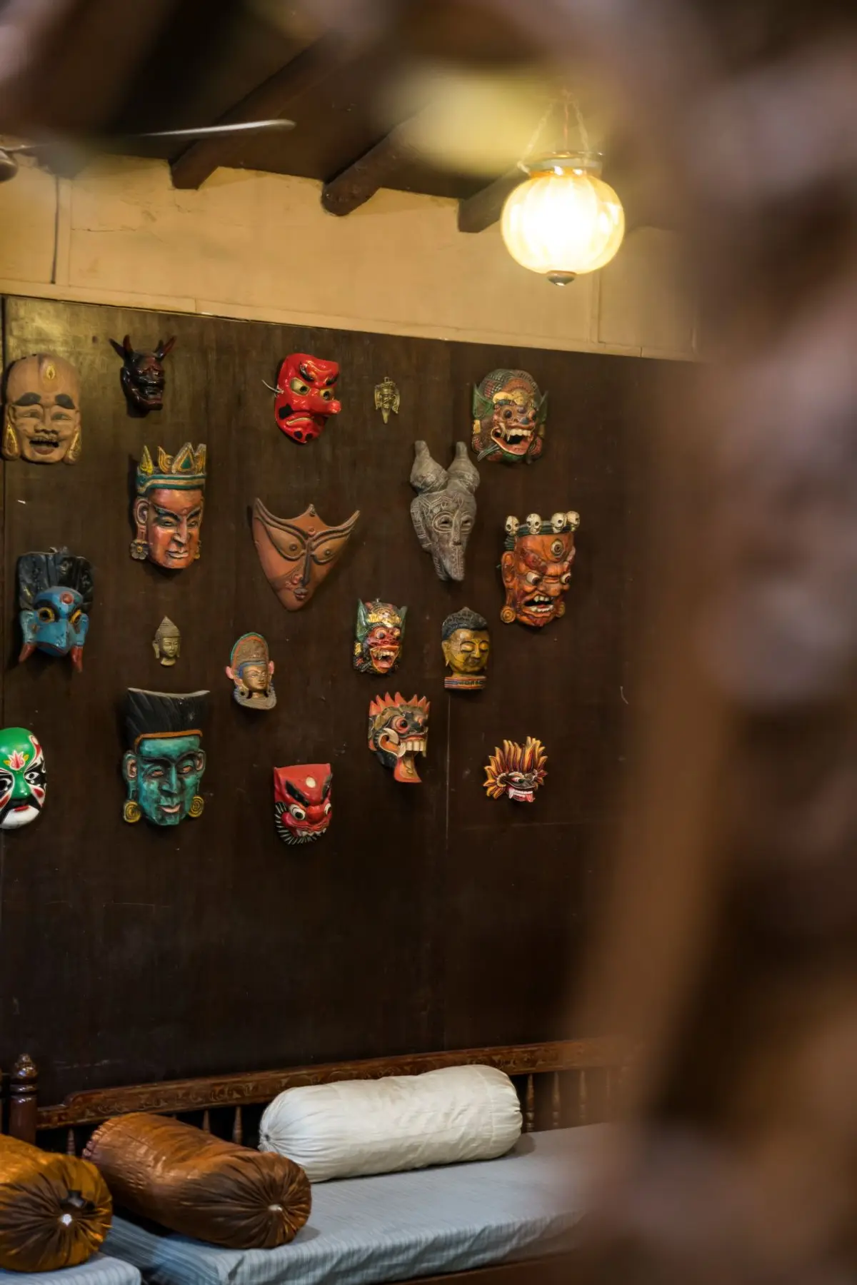 The Home Owner is a collector of antique furniture and has decorated the home with global artefacts, like these masks in the living room.