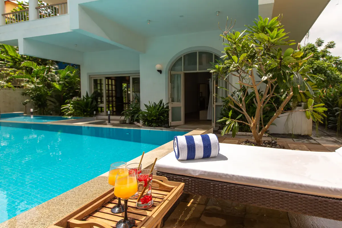 The urge to not step out of your large, cheery room is only weakened by the stunning pool and ample seating area. Play some groovy tunes to suit the vibe of the home as you sip on your favourite cocktail by the pool.